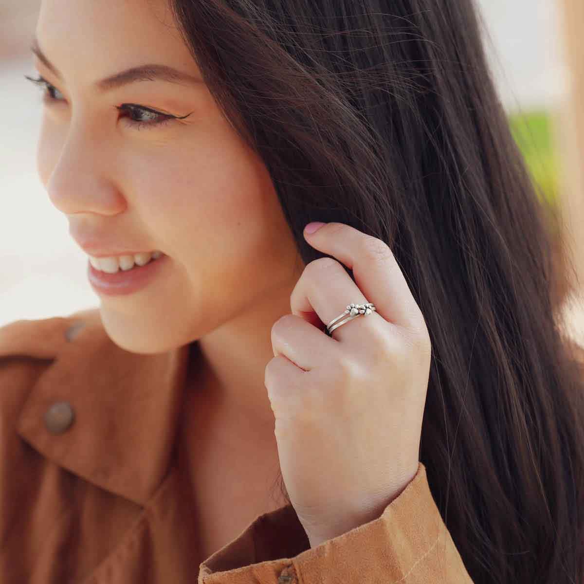 Girl wearing a Furry Footprint Dainty Ring handcrafted in sterling silver