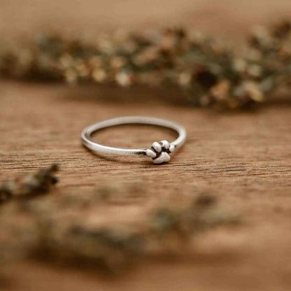 Girl holding a Furry Footprint Dainty Ring handcrafted in sterling silver in a lisa leonard box