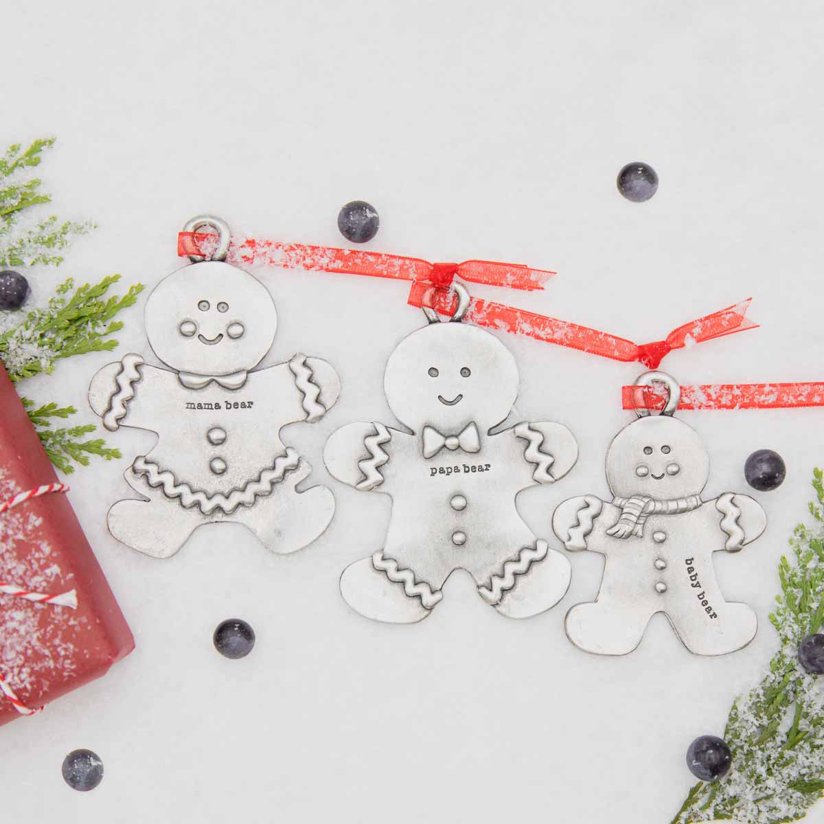 Gingerbread boy ornament  hand-molded and cast in fine pewter hung from a sheer red ribbon with a personalized word along with rest of gingerbread family