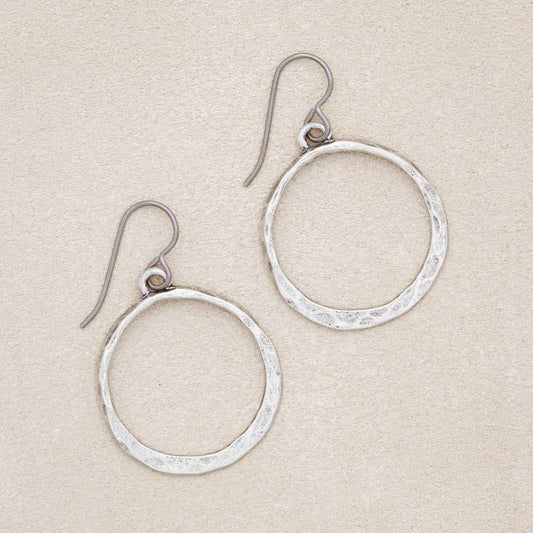 Hammered Hoop earrings, handcrafted in pewter, on a beige background