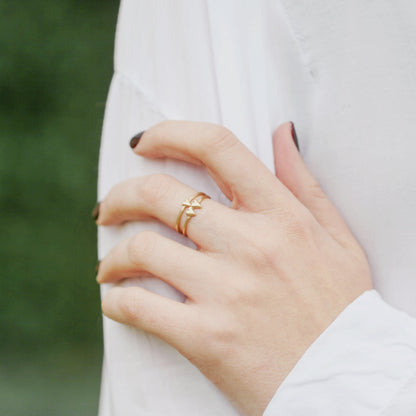 girl wearing a 10k yellow gold sweet love ring - one heart paired with a two heart ring