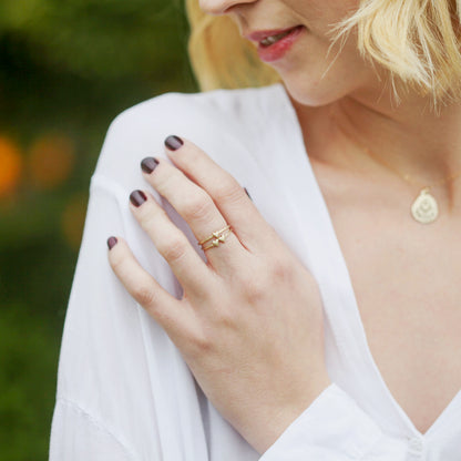 girl wearing a 14k yellow gold sweet love ring - one heart paired with a two heart ring