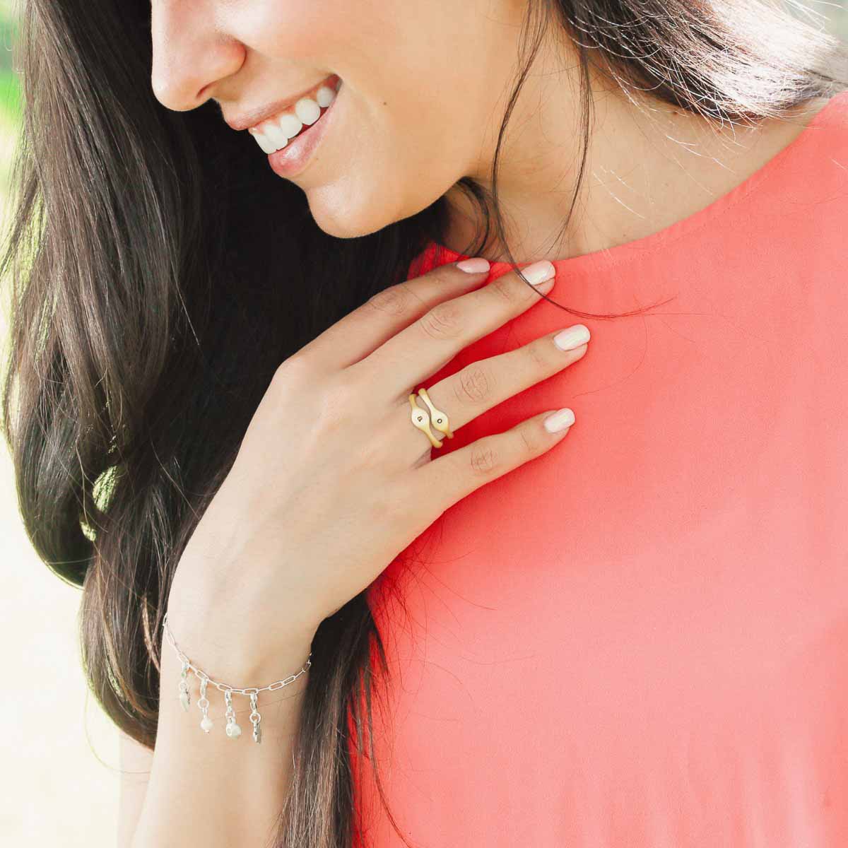 Girl wearing her Initial stacking ring handcrafted and cast in 10k yellow gold then hand-stamped with an initial