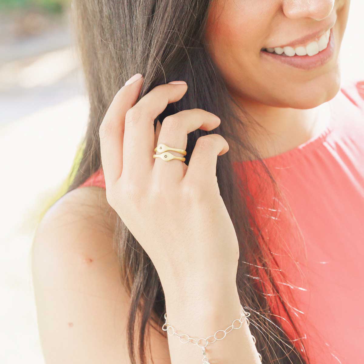 Girl wearing her Initial stacking ring handcrafted and cast in 10k yellow gold then hand-stamped with an initial