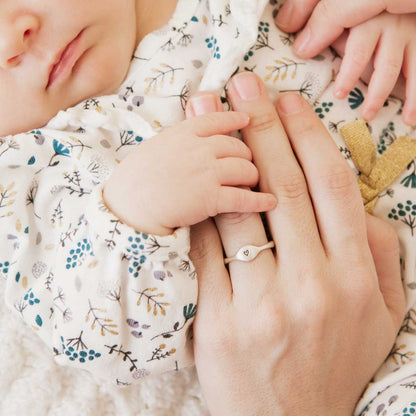 Mom wearing her Initial stacking ring handcrafted and cast in sterling silver then hand-stamped with an initial along with her children