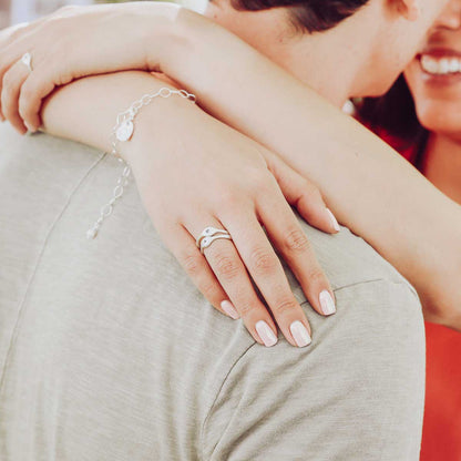 Girl wearing her Initial stacking ring handcrafted and cast in sterling silver then hand-stamped with an initial along with other sterling silver jewelry