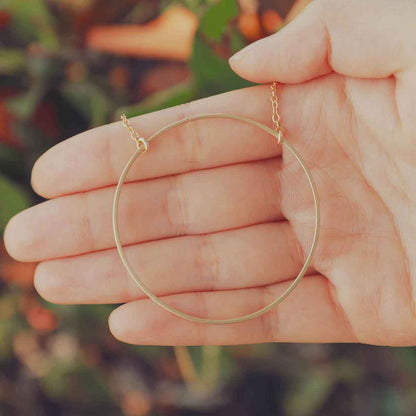 Woman wearing a gold filled It All Matters Circle Necklace in her kitchen