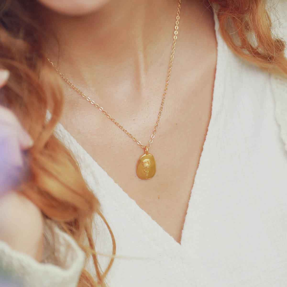 girl wearing a gold plated January birth flower necklace with an 18" gold filled link chain