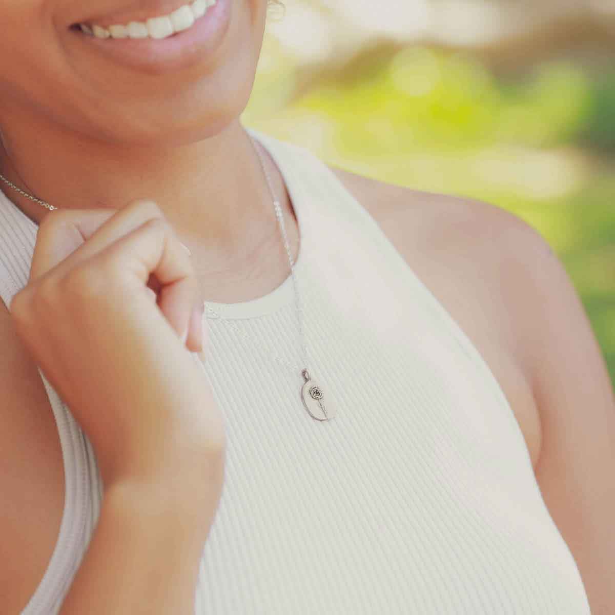 girl wearing a sterling silver January birth flower necklace