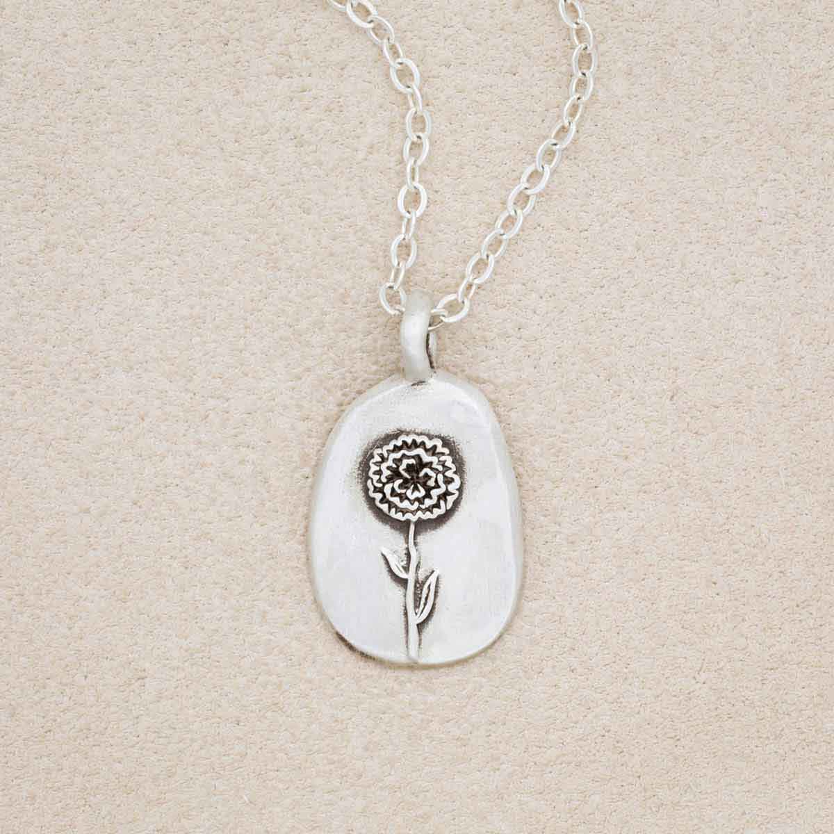 sterling silver January birth flower necklace, on beige background