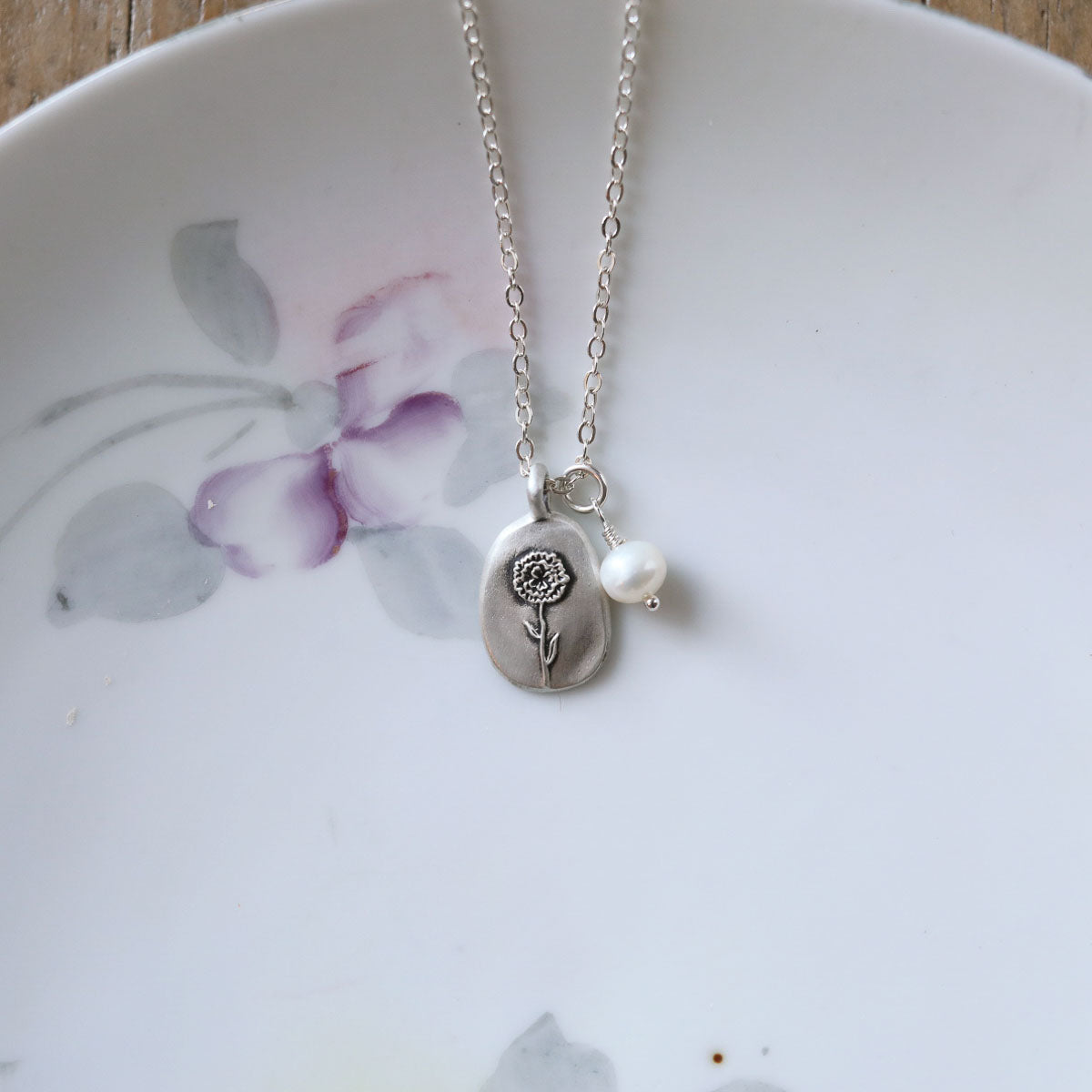 January birth flower necklace handcrafted in sterling silver with a special birth month charm strung with a vintage freshwater pearl