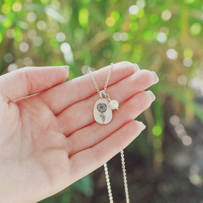 January birth flower necklace handcrafted in sterling silver with a special birth month charm strung with a vintage freshwater pearl