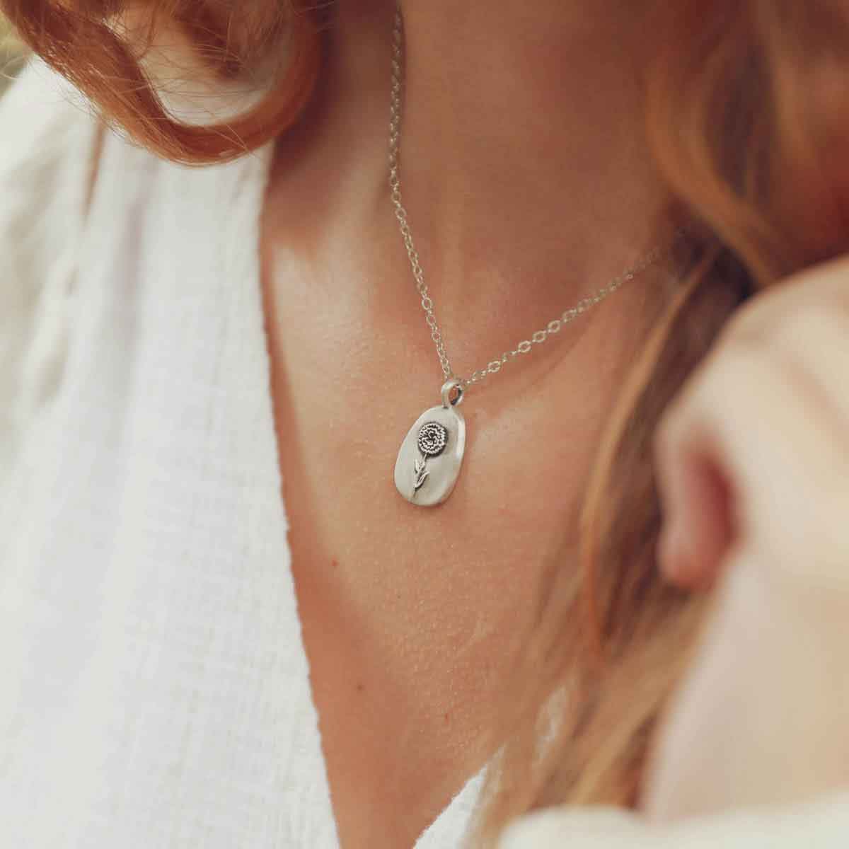 girl holding a sterling silver January birth flower necklace