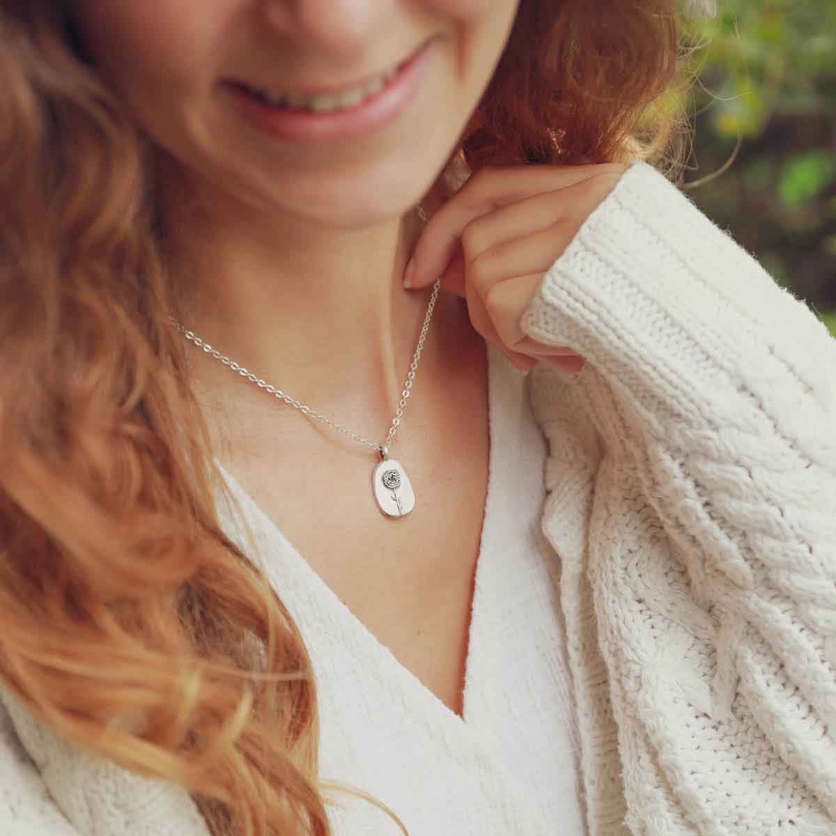 girl wearing a sterling silver January birth flower necklace