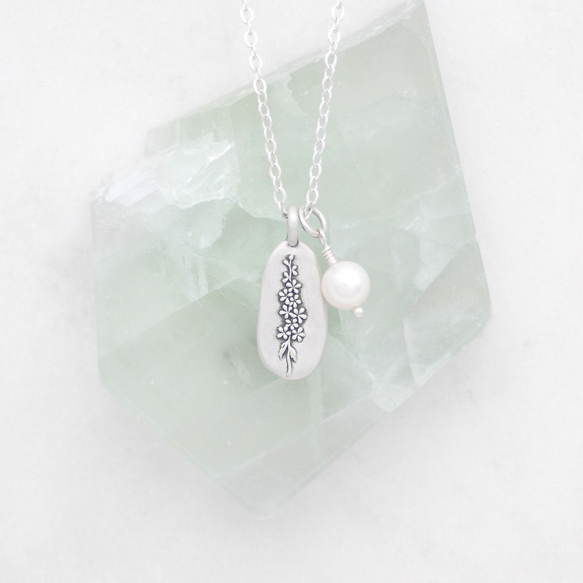 July birth flower necklace handcrafted in sterling silver with a special birth month charm strung with a vintage freshwater pearl