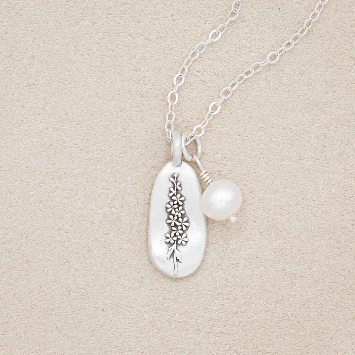 July birth flower necklace handcrafted in sterling silver with a special birth month charm strung with a vintage freshwater pearl