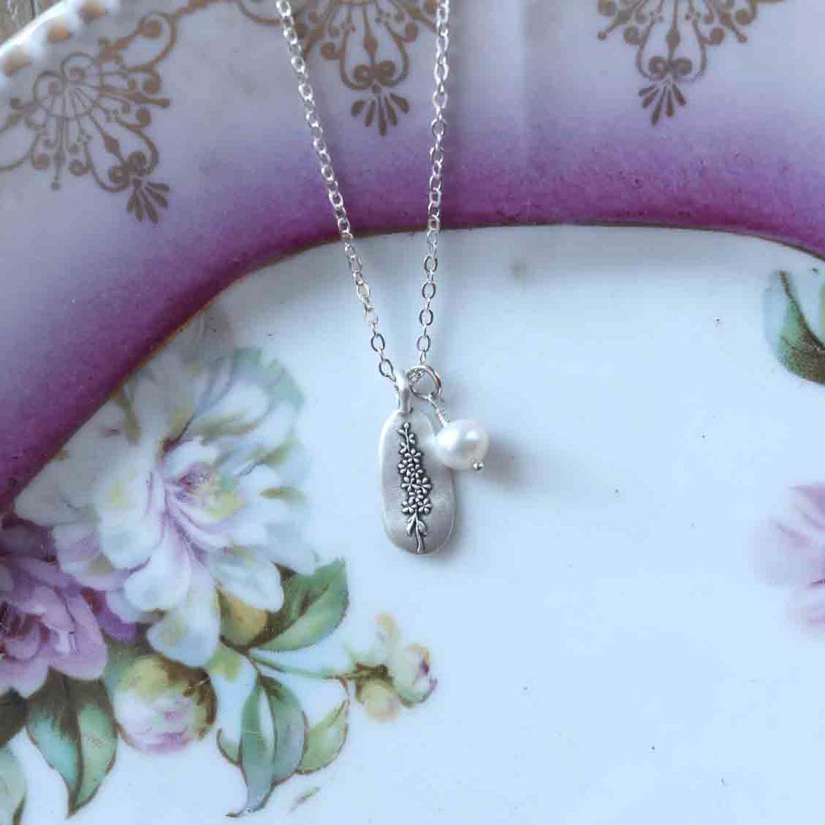 July birth flower necklace handcrafted in sterling silver with a special birth month charm strung with a vintage freshwater pearl