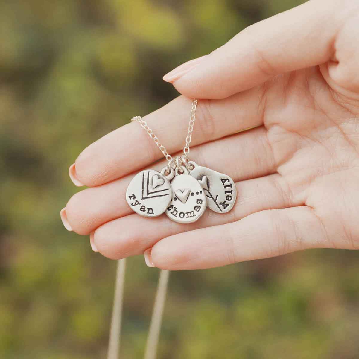 girls holding a Personalized jumble of love necklace sterling silver