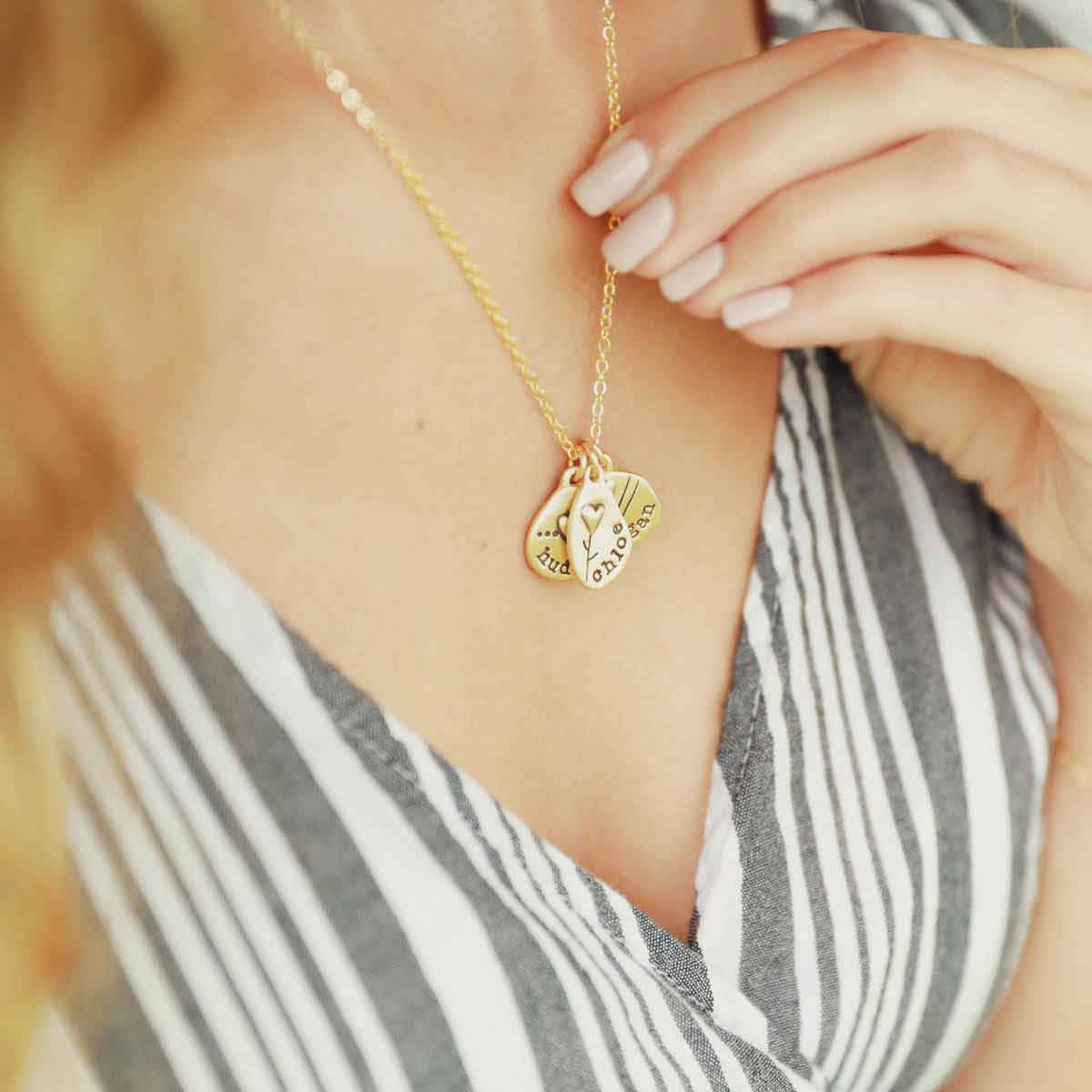 woman wearing her handcrafted 10k yellow gold personalized jumble of love necklace