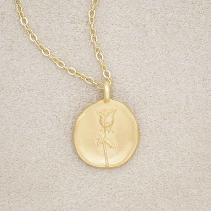 gold plated June birth flower necklace with an 18" gold filled link chain, on beige background