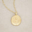 gold plated June birth flower necklace with an 18" gold filled link chain, on beige background