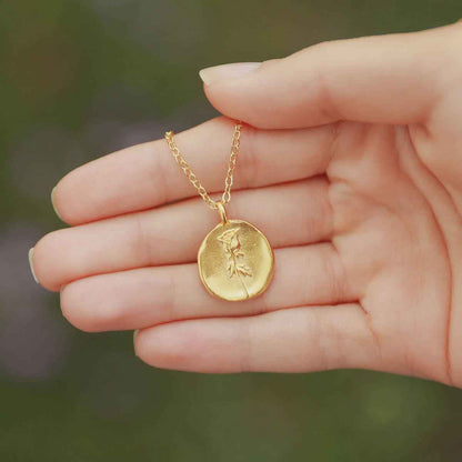 girl wearing a gold plated June birth flower necklace with an 18" gold filled link chain