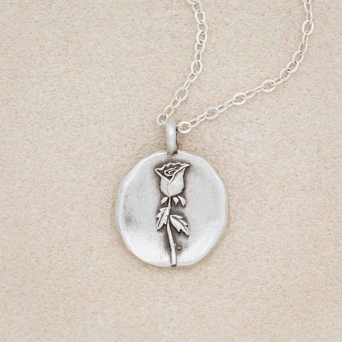 sterling silver June birth flower necklace, on beige background