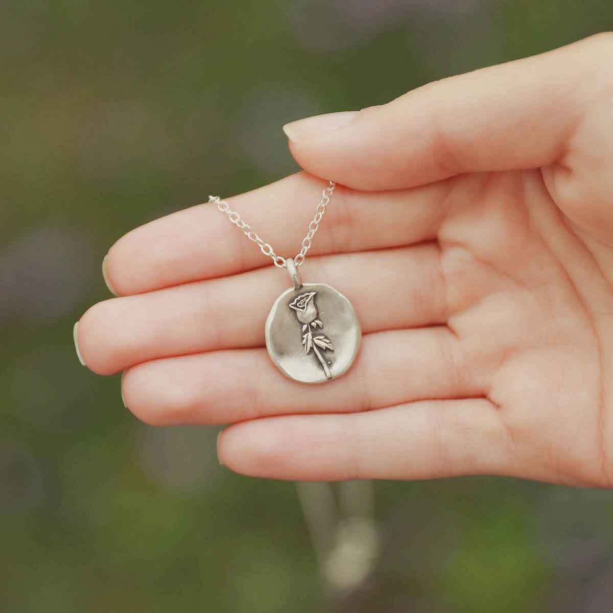 girl wearing a sterling silver June birth flower necklace