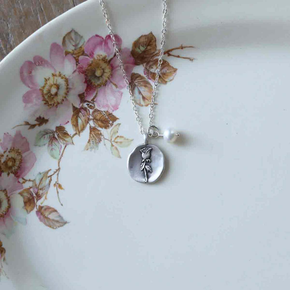 June birth flower necklace handcrafted in sterling silver with a special birth month charm strung with a vintage freshwater pearl