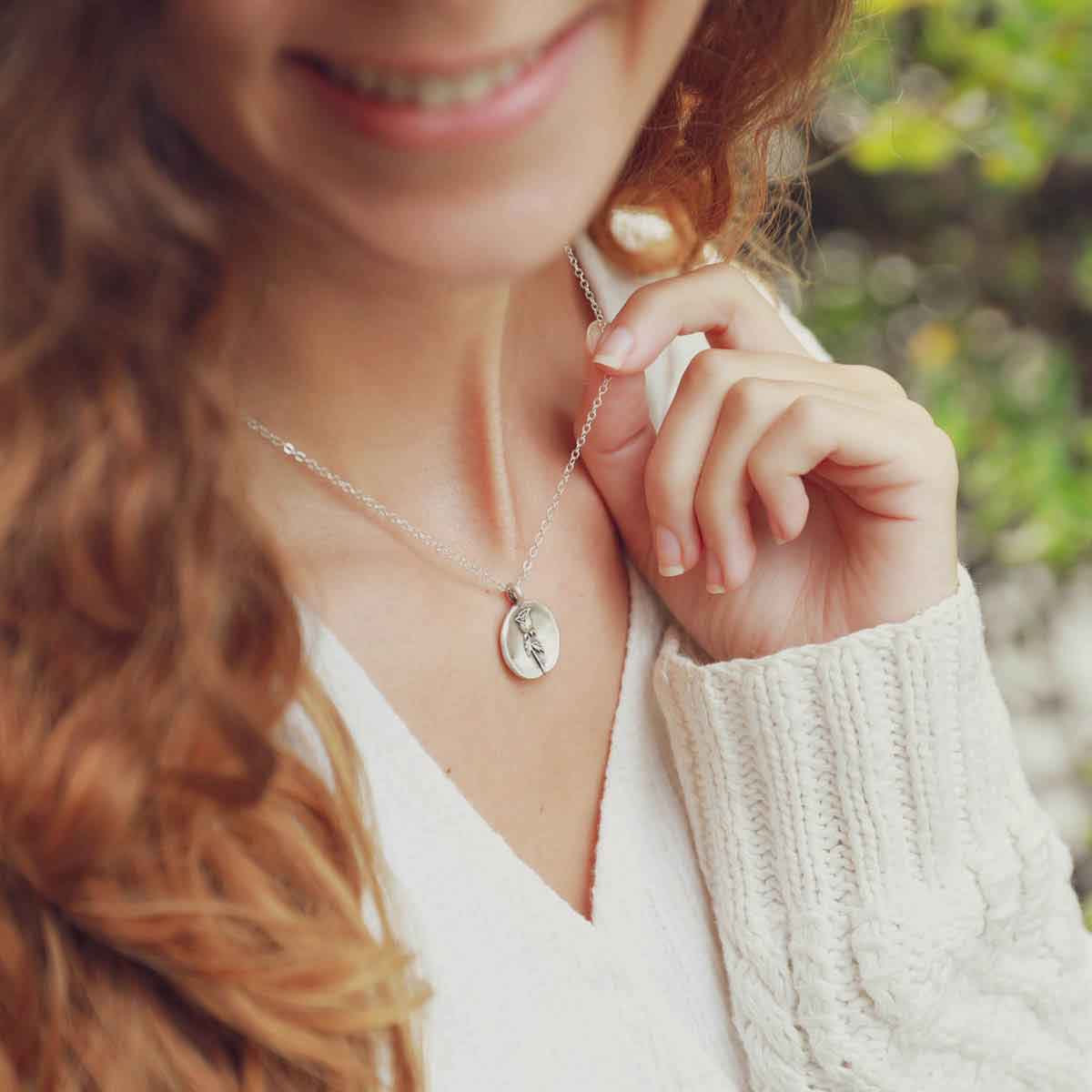 girl wearing a sterling silver June birth flower necklace