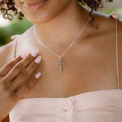 woman wearing a sterling silver Justified Cross Necklace