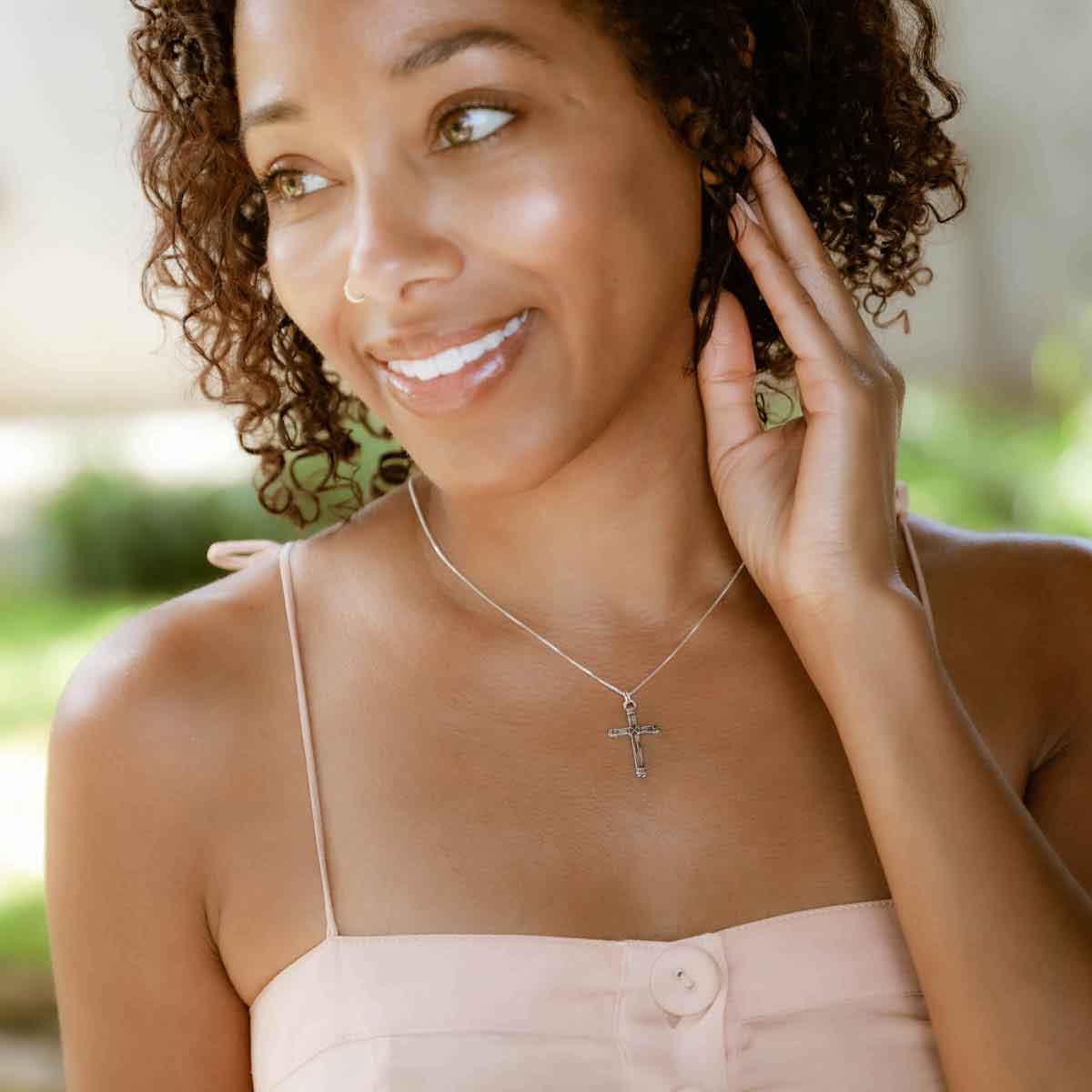 woman wearing a sterling silver Justified Cross Necklace