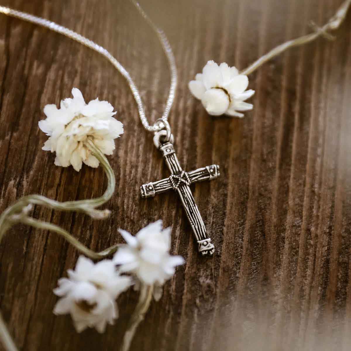 woman wearing a sterling silver Justified Cross Necklace