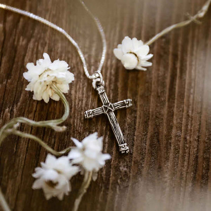 woman wearing a sterling silver Justified Cross Necklace