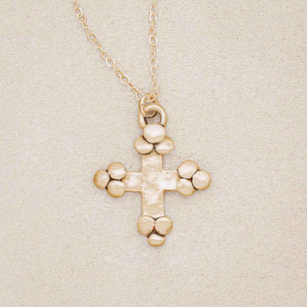 Known and loved cross necklace handcrafted in 10k yellow gold with the cross charm hanging from choice of chain