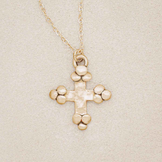 Known and loved cross necklace handcrafted in 10k yellow gold with the cross charm hanging from choice of chain