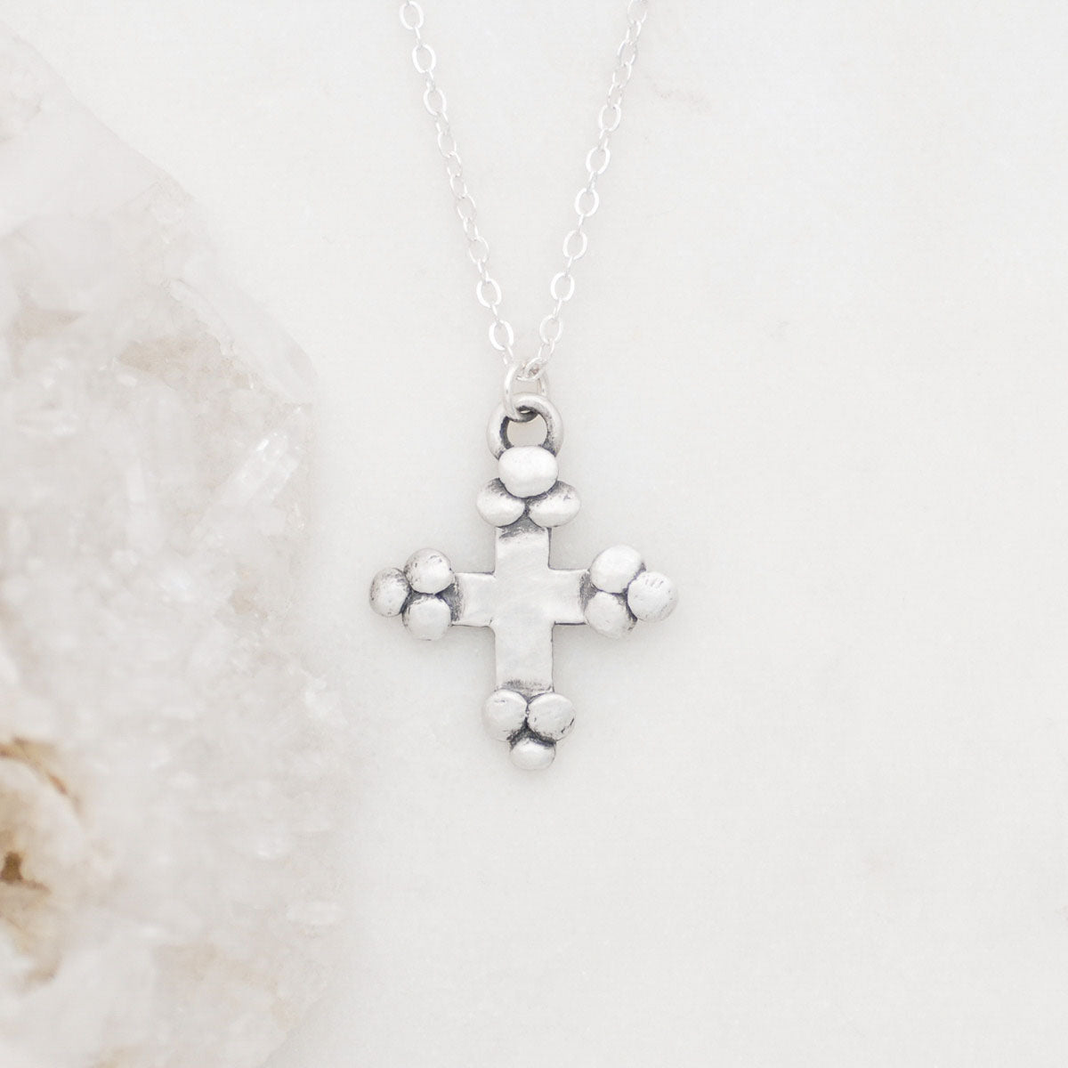 Known and loved cross necklace handcrafted in sterling silver with the cross charm hanging from choice of chain