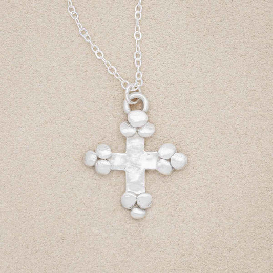 Known and loved cross necklace handcrafted in sterling silver with the cross charm hanging from choice of chain