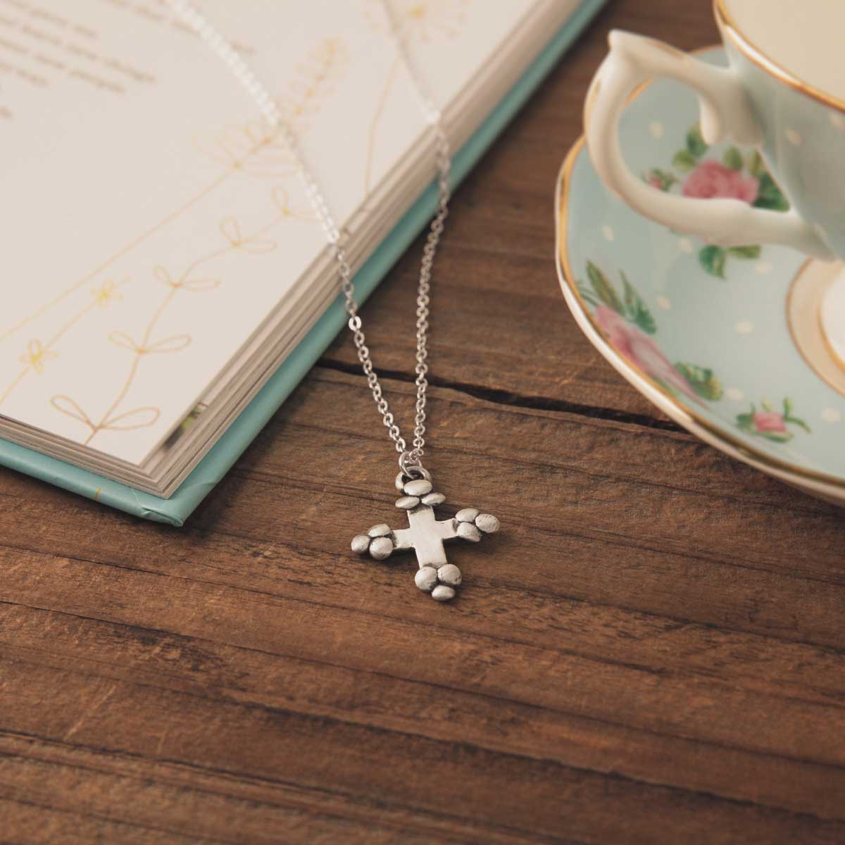 Known and loved cross necklace handcrafted in sterling silver with the cross charm hanging from choice of chain