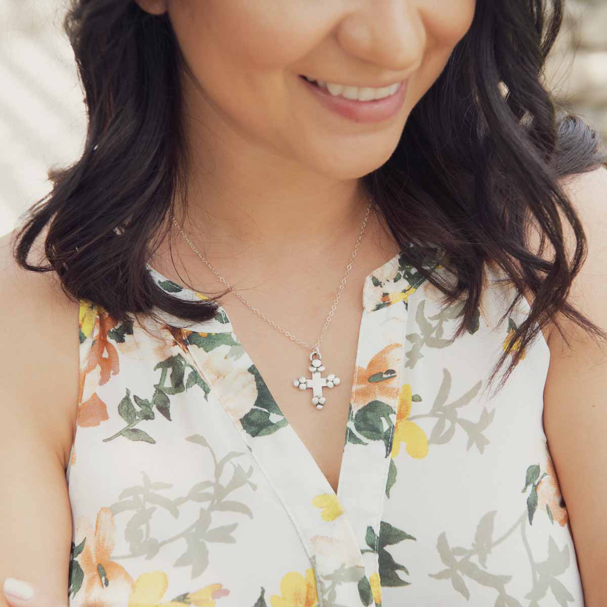 Girl wearing her Known and loved cross necklace handcrafted in sterling silver with the cross charm hanging from choice of chain