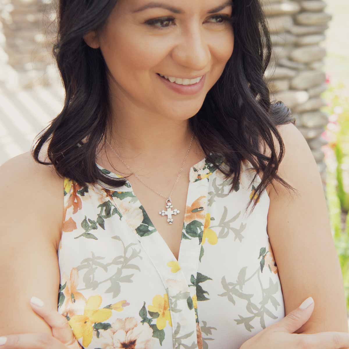 Girl wearing her Known and loved cross necklace handcrafted in sterling silver with the cross charm hanging from choice of chain