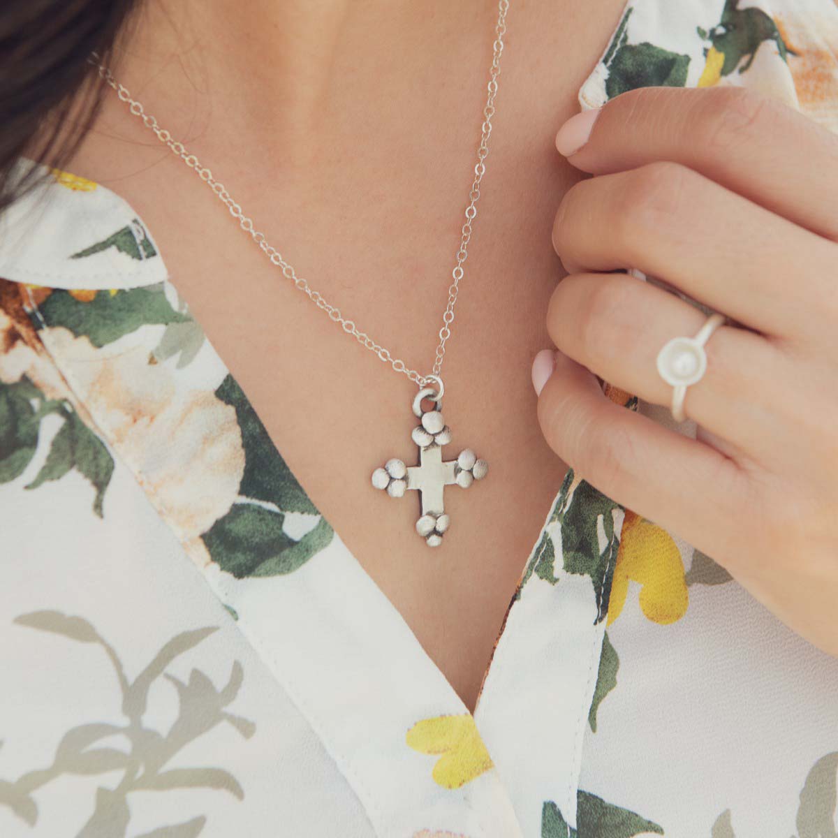 Girl wearing her Known and loved cross necklace handcrafted in sterling silver with the cross charm hanging from choice of chain