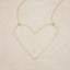 A gold filled Large Peaceful Heart Necklace, on beige background