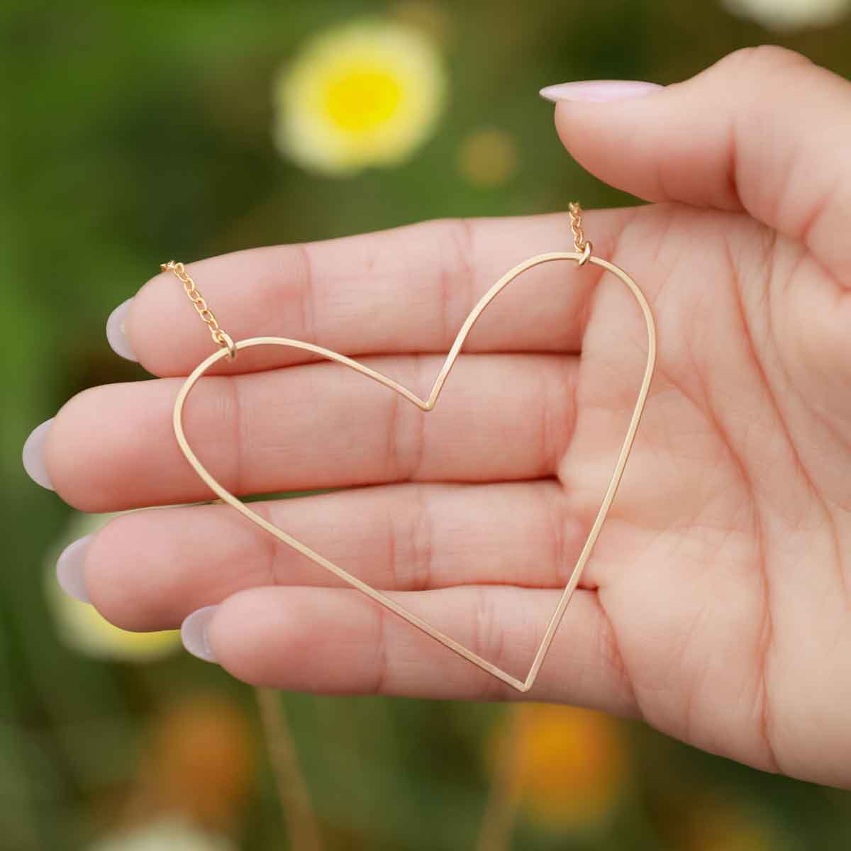 Girl wearing a gold filled Large Peaceful Heart Necklace