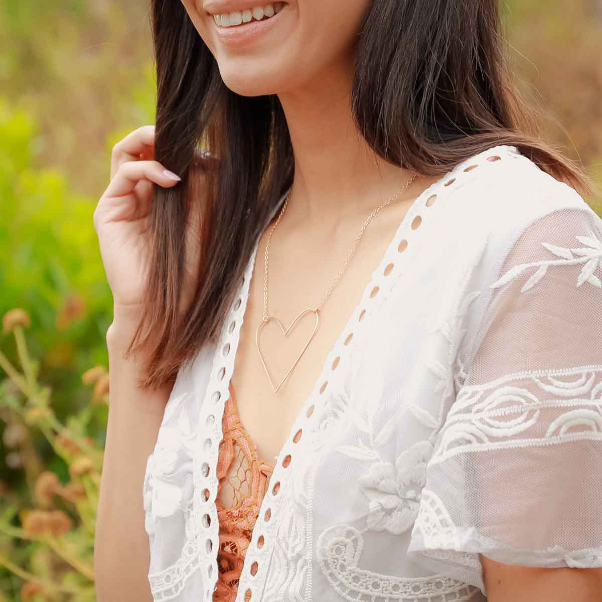 Girl wearing a gold filled Large Peaceful Heart Necklace