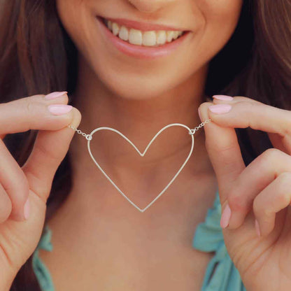 woman wearing a sterling silver Large Peaceful Heart Necklace