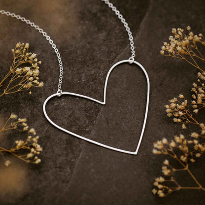 woman wearing a sterling silver Large Peaceful Heart Necklace in her kitchen