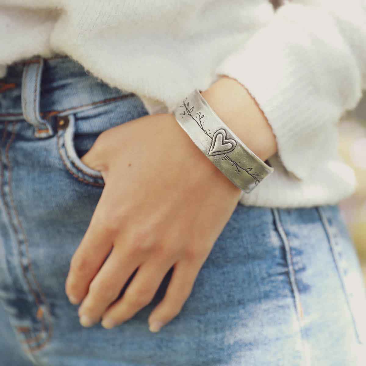 girl wearing pewter let love grow cuff