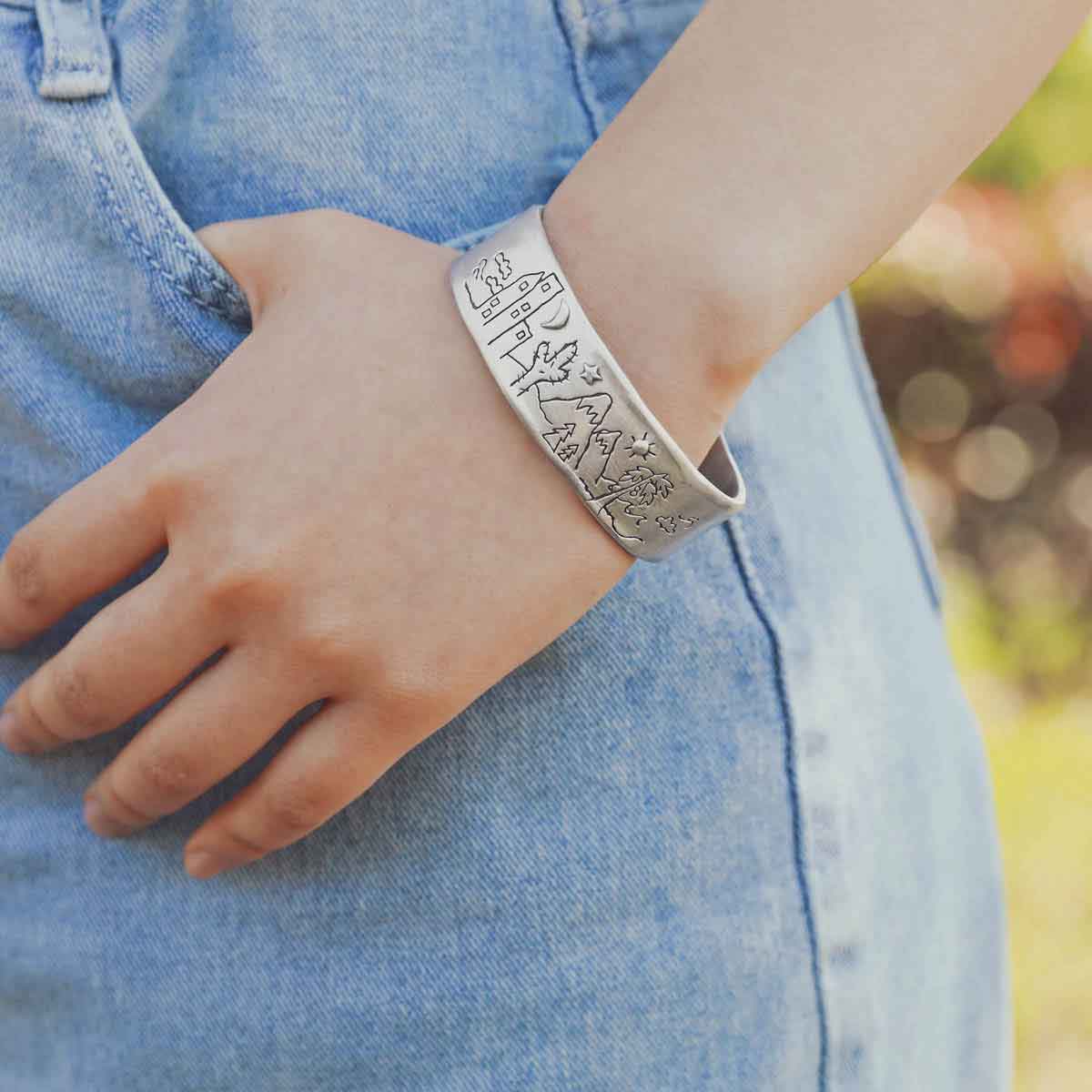 girl wearing a Let's Explore Together Cuff