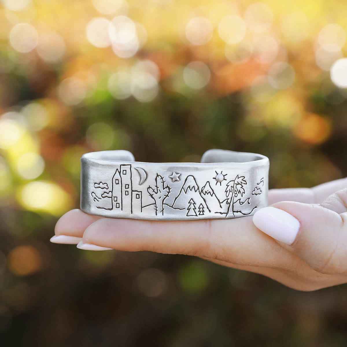 girl holding a Let's Explore Together Cuff